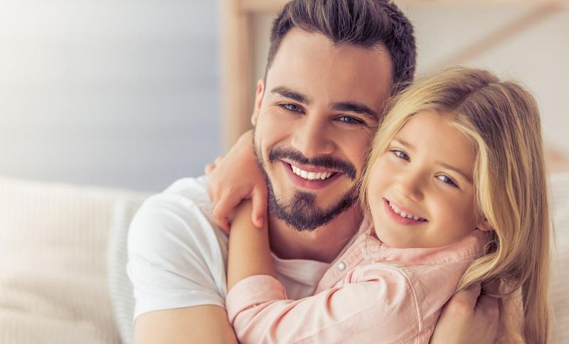 A father and daughter share a warm moment together, highlighting the importance of paternal affirmation