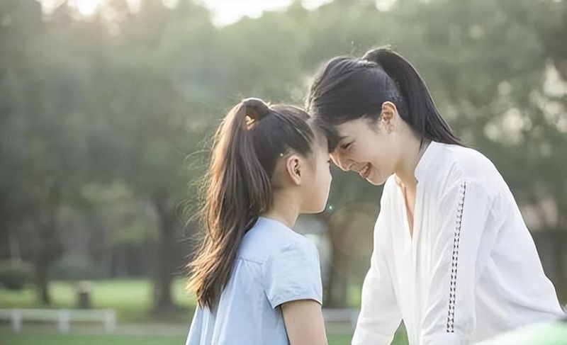 A mother and daughter sitting together, sharing a warm moment of connection